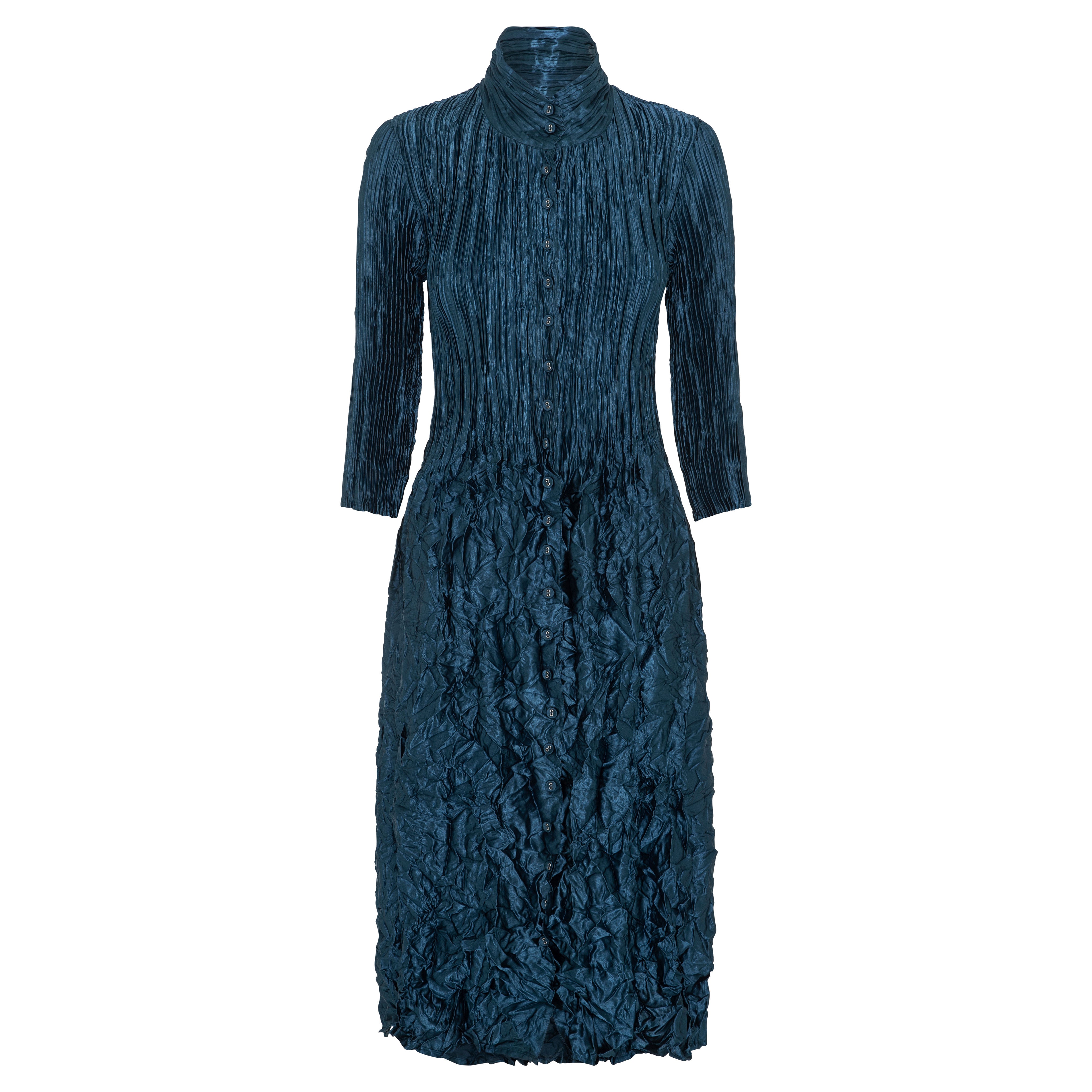 A long sleeve coat dress with a Nehru collar and metallic sheen, predominantly in a blue color.